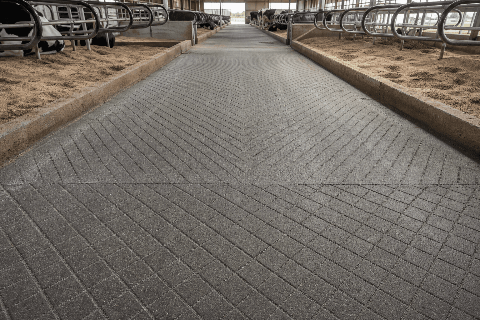 Barn alley showing diamond grooving in the foreground transitioning to tractor herringbone pattern in the background, cut in one job